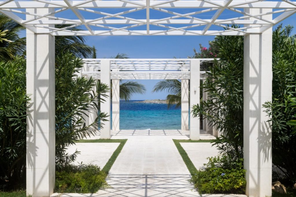 Elegant outdoor wedding venue overlooking the beach at a luxury Caribbean resort.